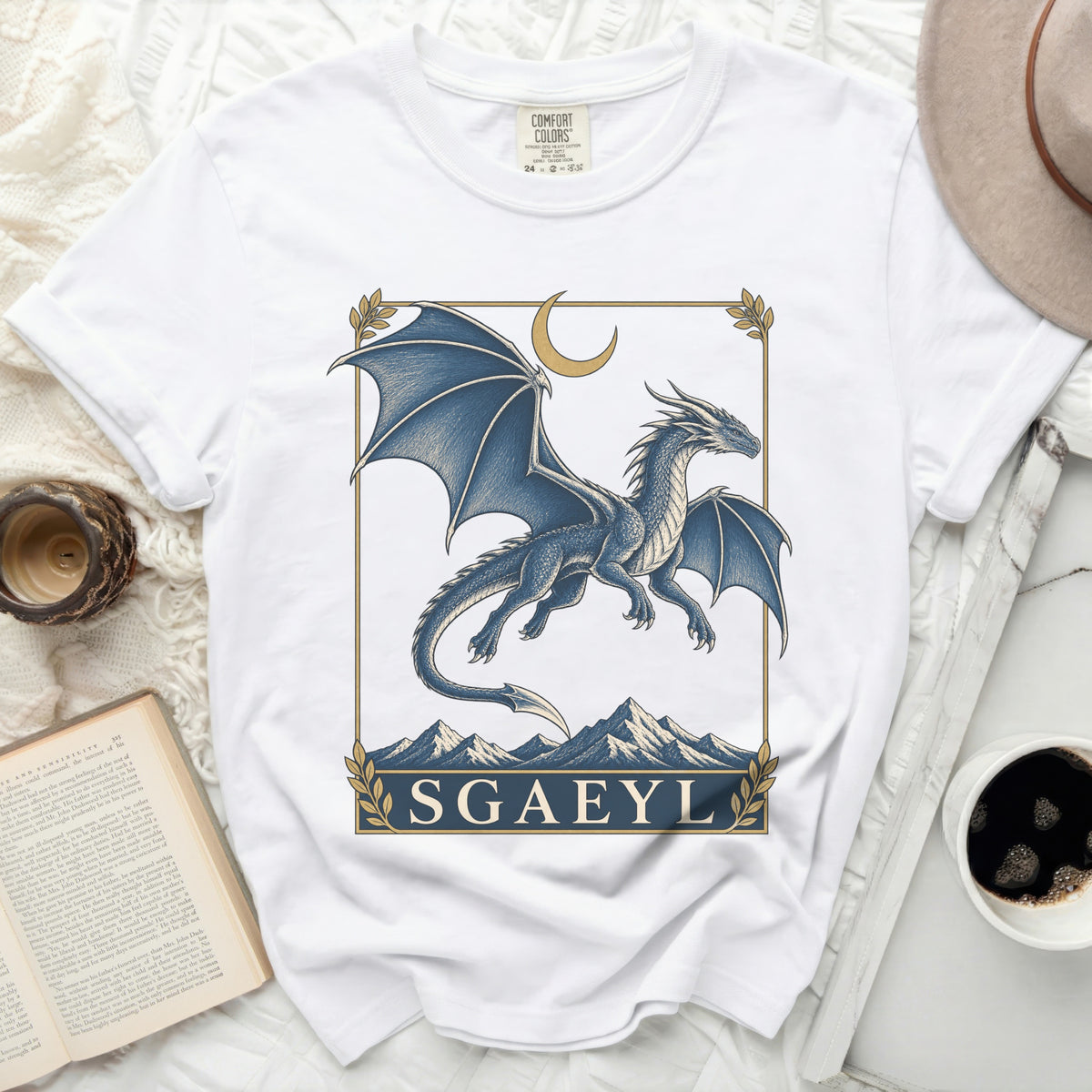 White t-shirt with a blue dragon graphic and the text "SGAEYL".