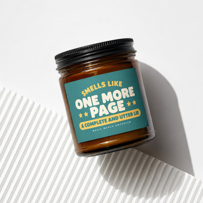 Amber candle in glass jar with teal label that reads "Smells like one more page".