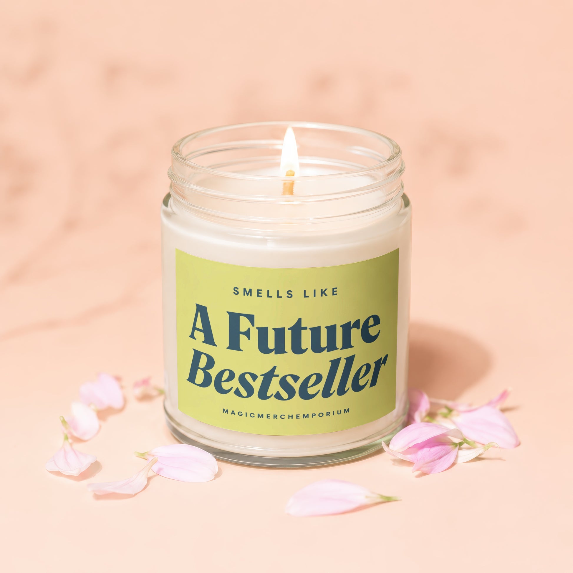 Jar candle that says "Smells Like A Future Bestseller" with pink petals.