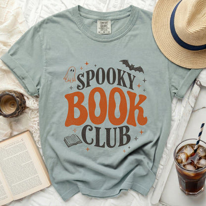 Light blue t-shirt with "Spooky Book Club" text, ghost, bat and book graphics.