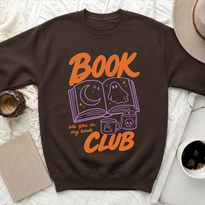 Dark brown sweatshirt with "BOOK CLUB" and spooky book-themed graphics.