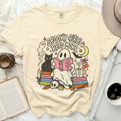 Ghost reading a book with "Spooky Girls Read More" and Halloween illustrations.