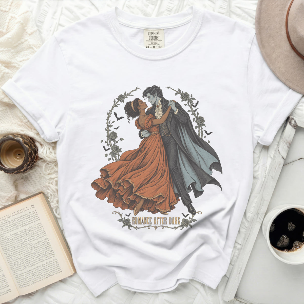 White t-shirt with a graphic of a vampire dancing with a woman, text "Romance After Dark."