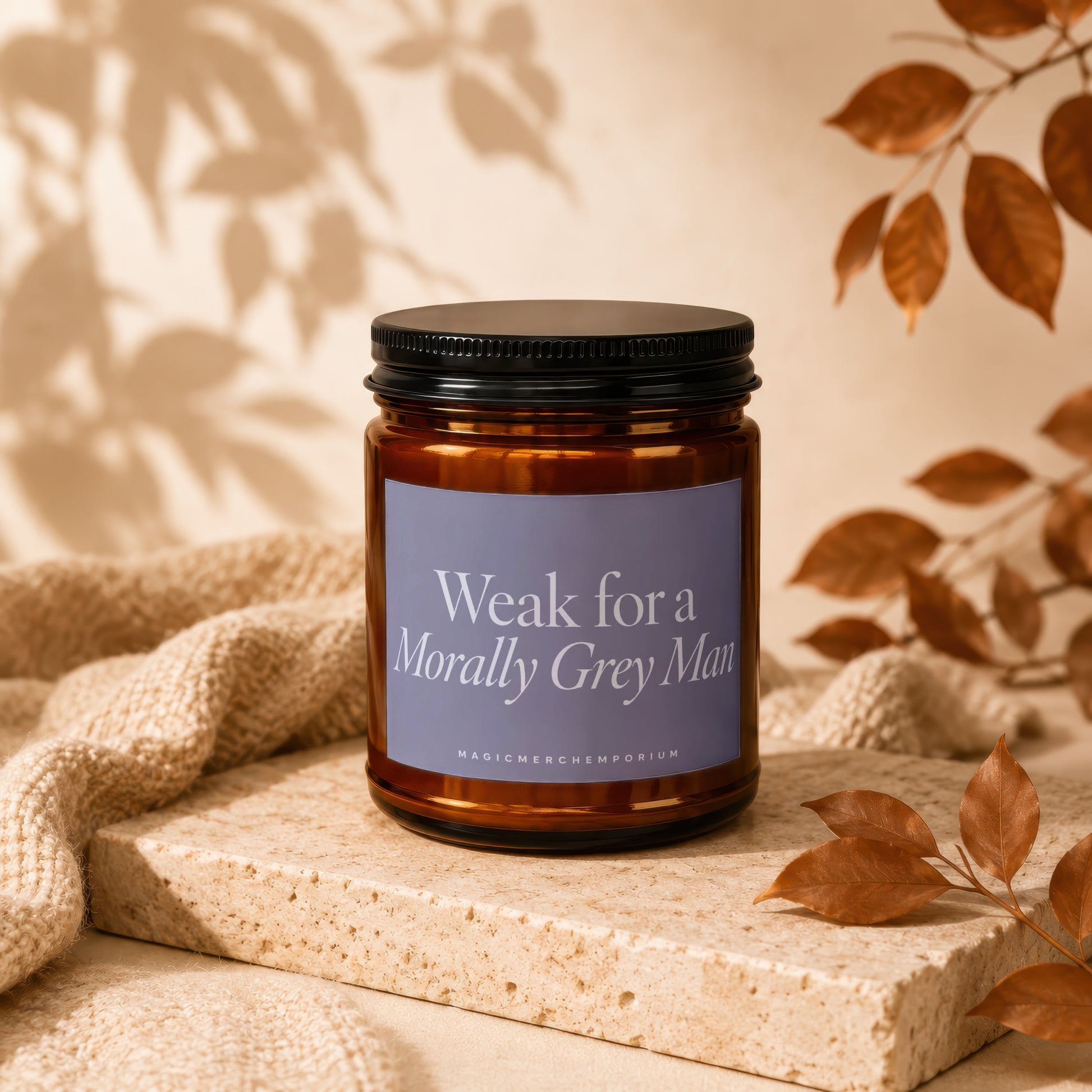 Amber jar candle with lavender label reading "Weak for a Morally Grey Man".