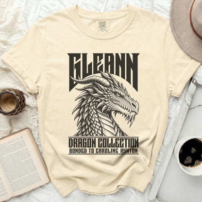 Cream t-shirt with black graphic of a dragon head and text "FLEANN DRAGON COLLECTION BONDED TO CAROLINE ASHTON".