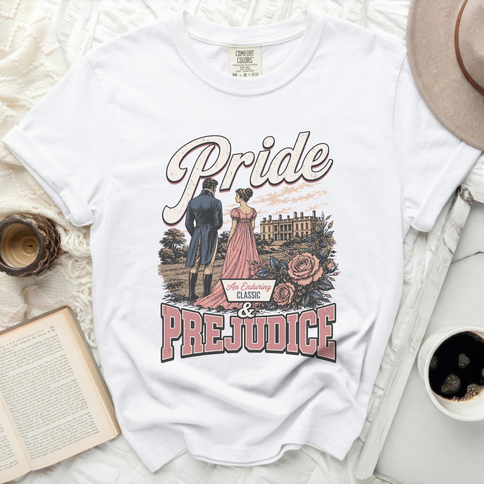 White t-shirt with "Pride & Prejudice" graphic featuring a couple and mansion.