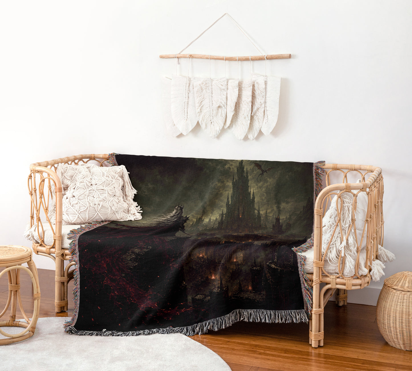 a cozy living room with a wicker bench, a black and red throw blanket with a castle scene, and a hanging white feather decoration on the wall.