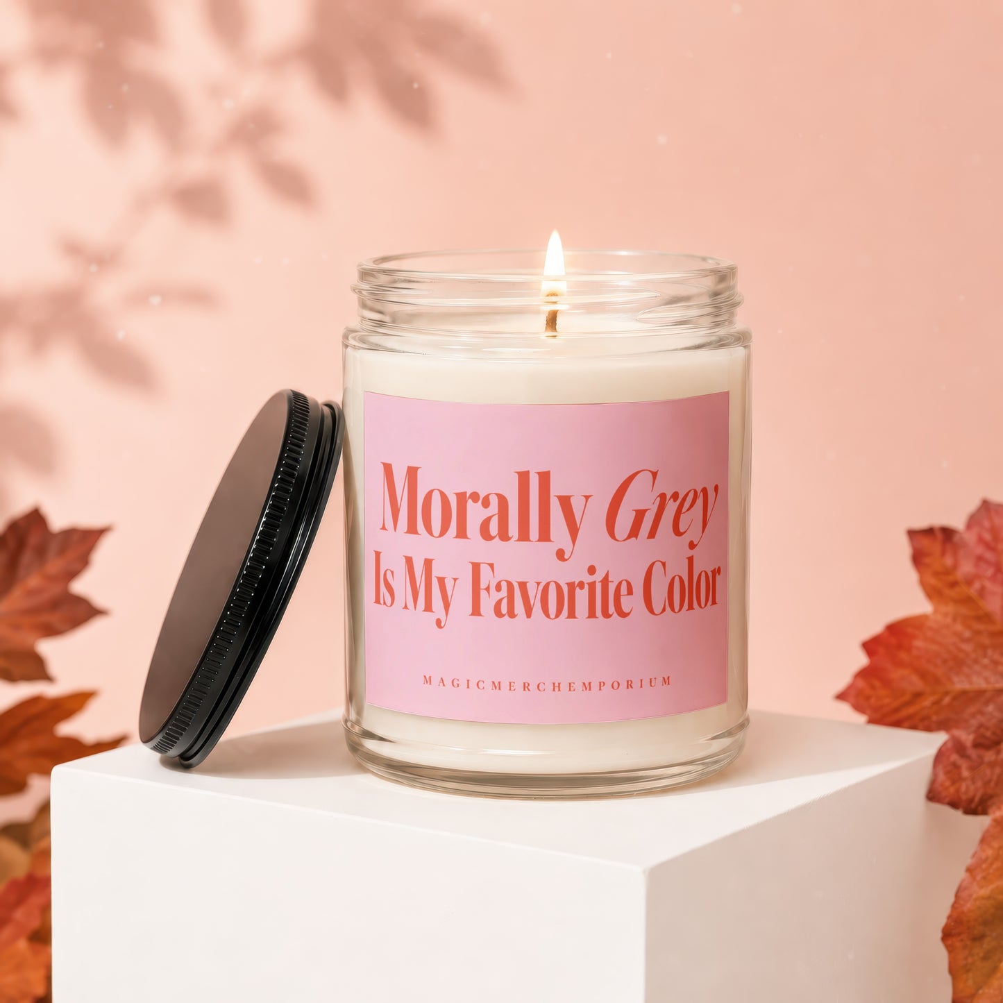 Lit candle with pink label reading "Morally Grey Is My Favorite Color"