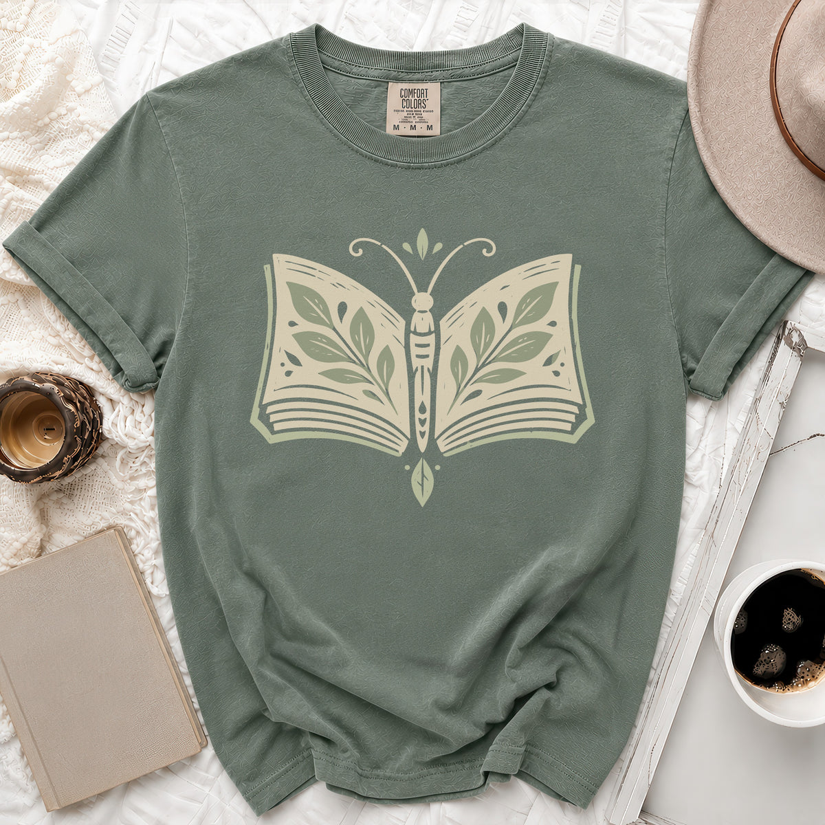 Green t-shirt with open book butterfly graphic and Comfort Colors label.
