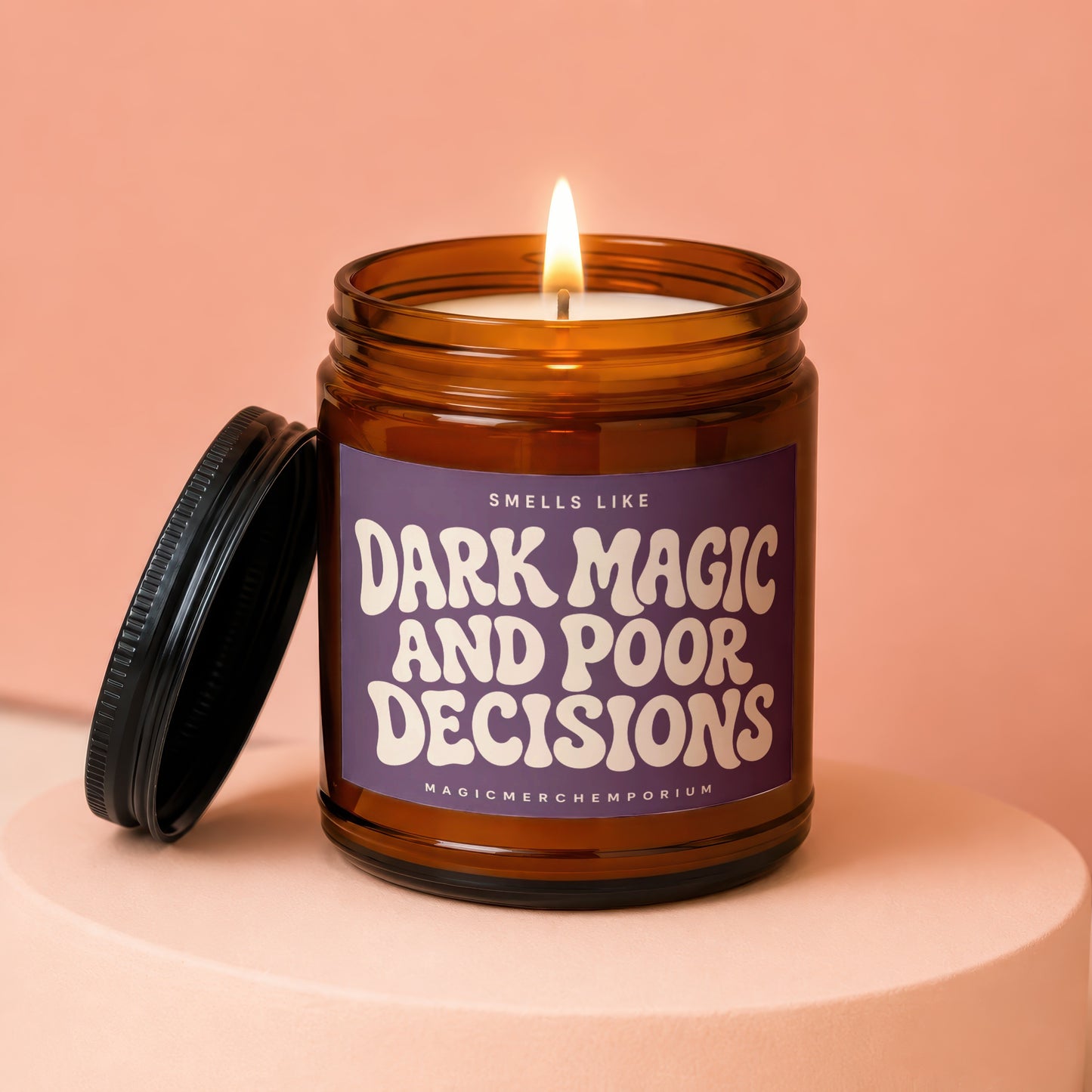 Burning amber jar candle with a purple label that reads "Smells Like Dark Magic and Poor Decisions."