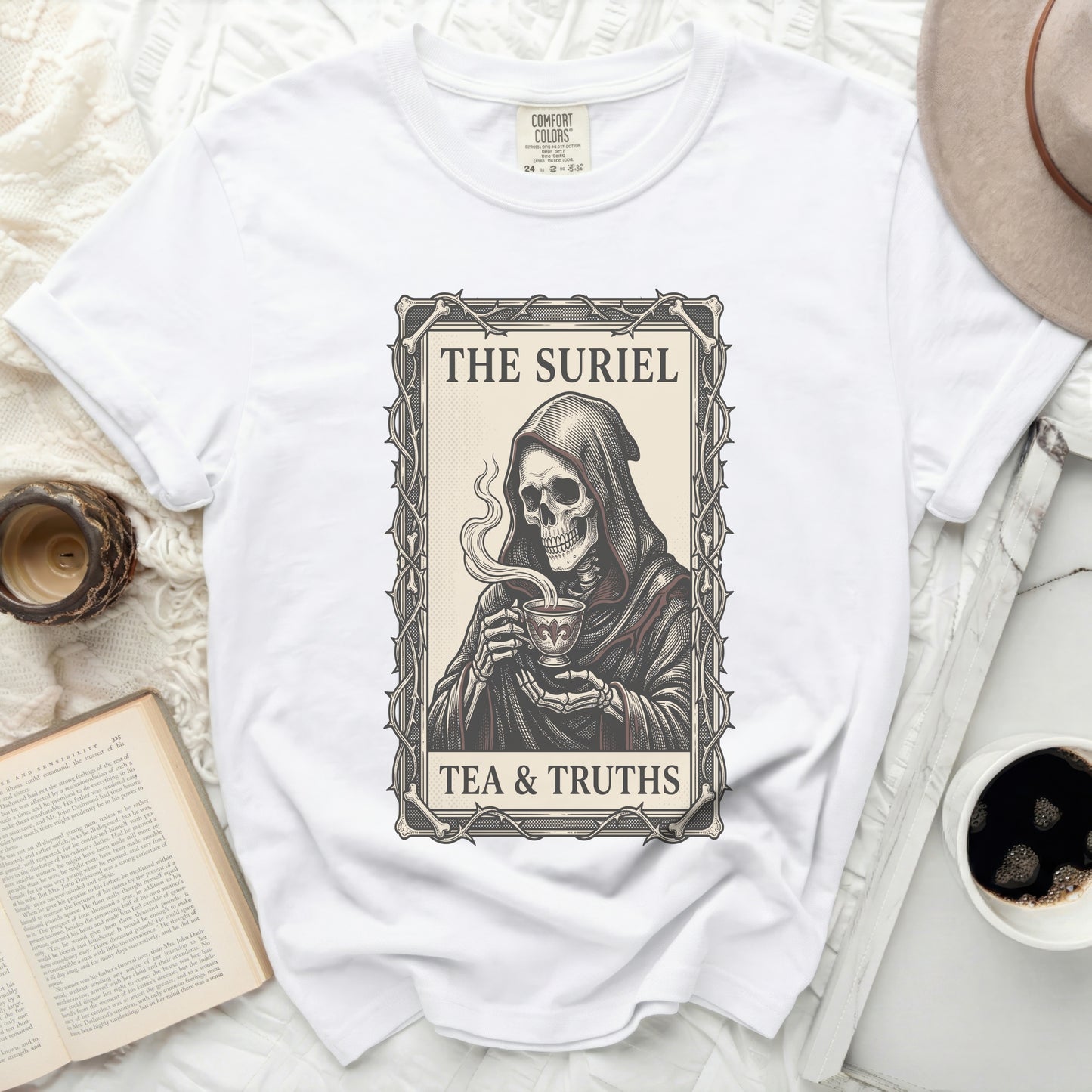 White t-shirt with grim reaper graphic reading "THE SURIEL TEA & TRUTHS".