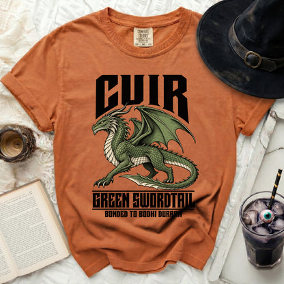 Orange Comfort Colors t-shirt with a green dragon graphic and text: CUIR, GREEN SWORDTAIL, BONDED TO BODHI DURRAN.