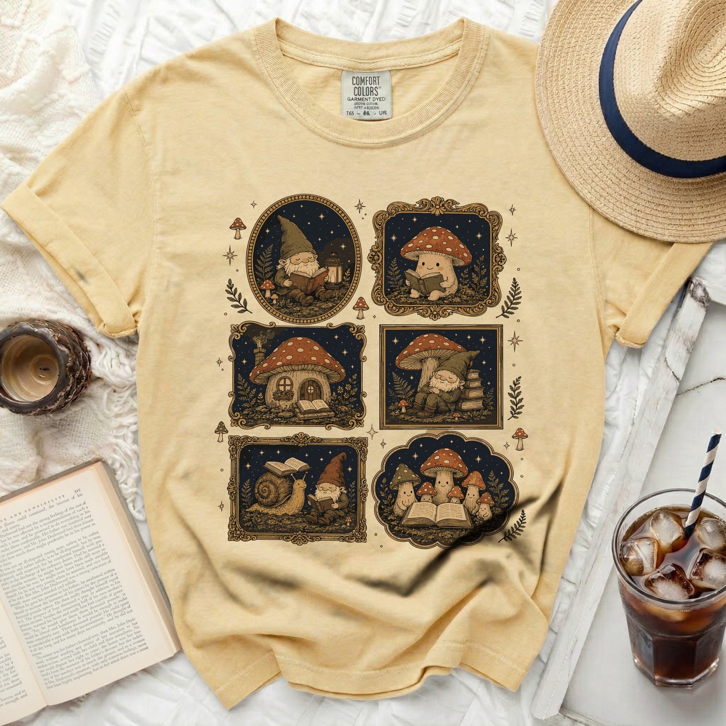 Yellow t-shirt with a print of gnomes and mushrooms reading books.