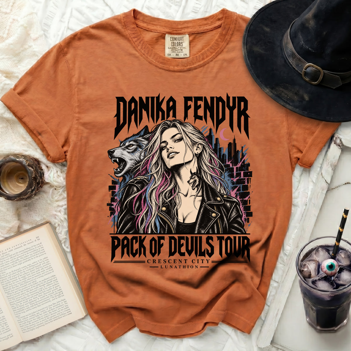 Danika Fendyr Pack of Devils Tour t-shirt with wolf and city graphic.