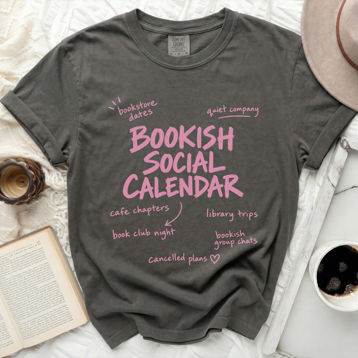 Bookish Social Calendar t-shirt with bookish activities and pink text.