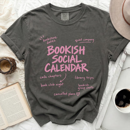 Bookish Social Calendar t-shirt with bookish activities and pink text.