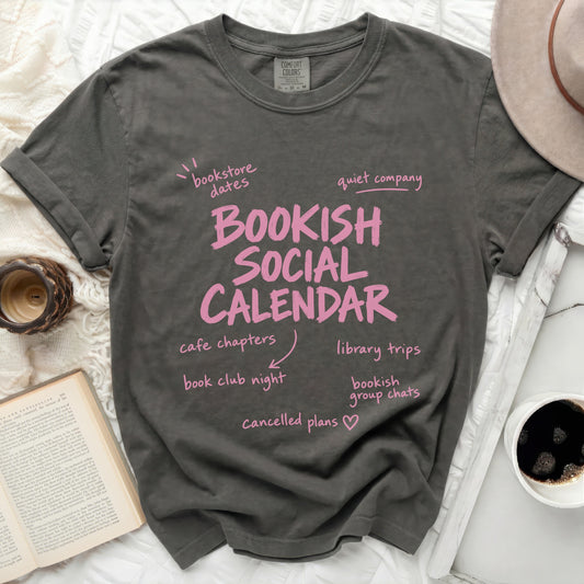 Bookish Social Calendar t-shirt with bookish activities and pink text.