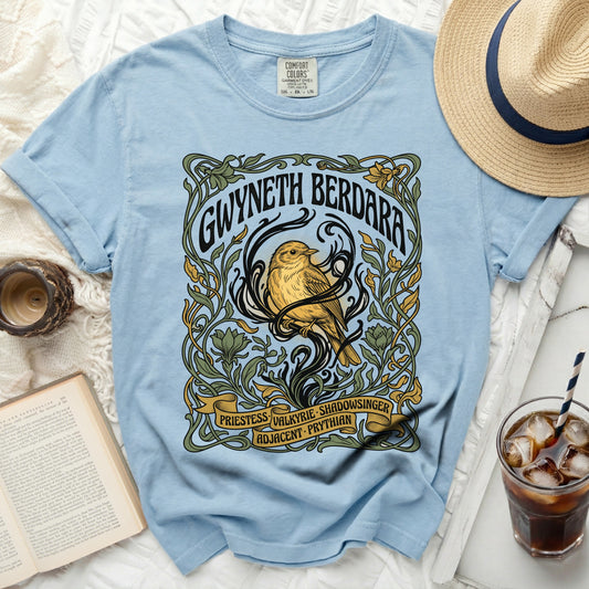 Light blue t-shirt with art nouveau design of bird and text.