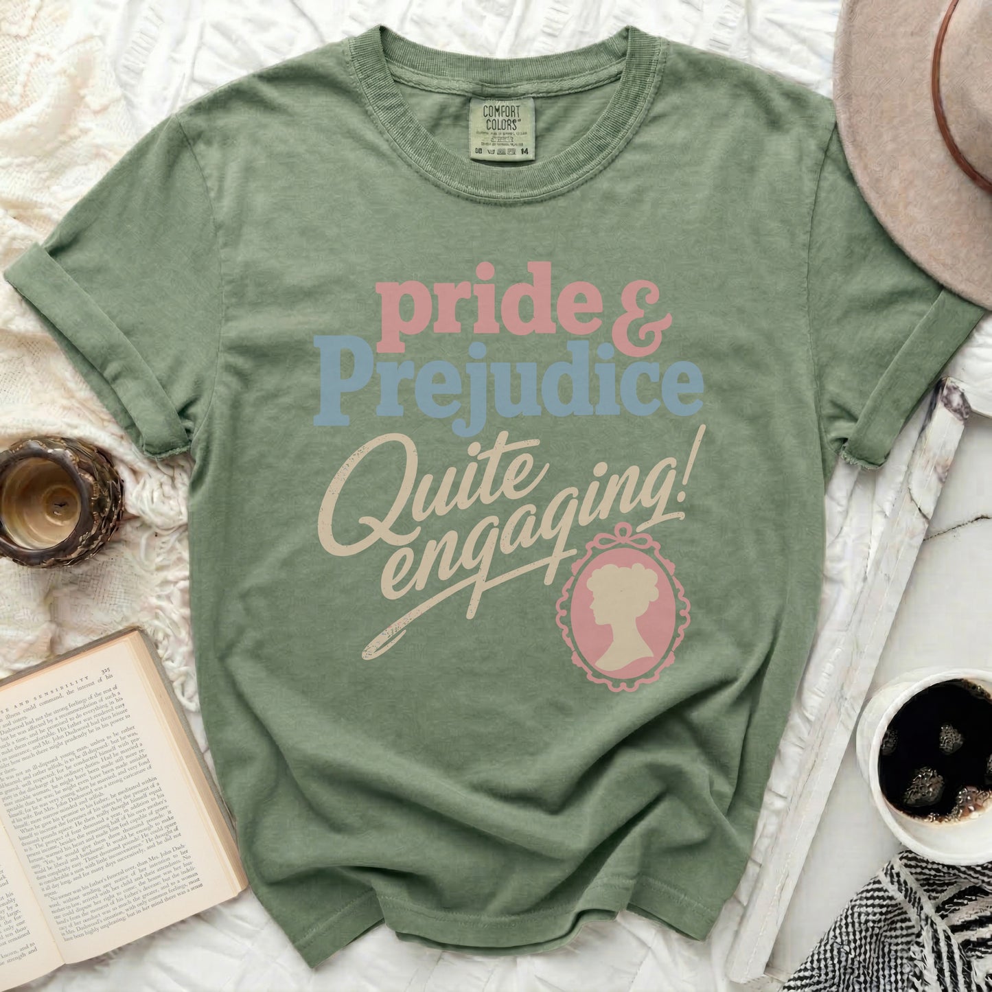 Sage green t-shirt with "Pride & Prejudice Quite Engaging!" text.