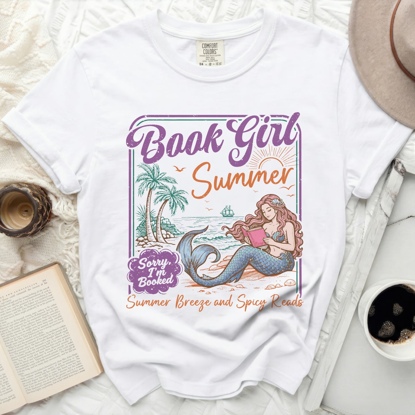 White t-shirt with a mermaid reading a book and "Book Girl Summer" text graphic.