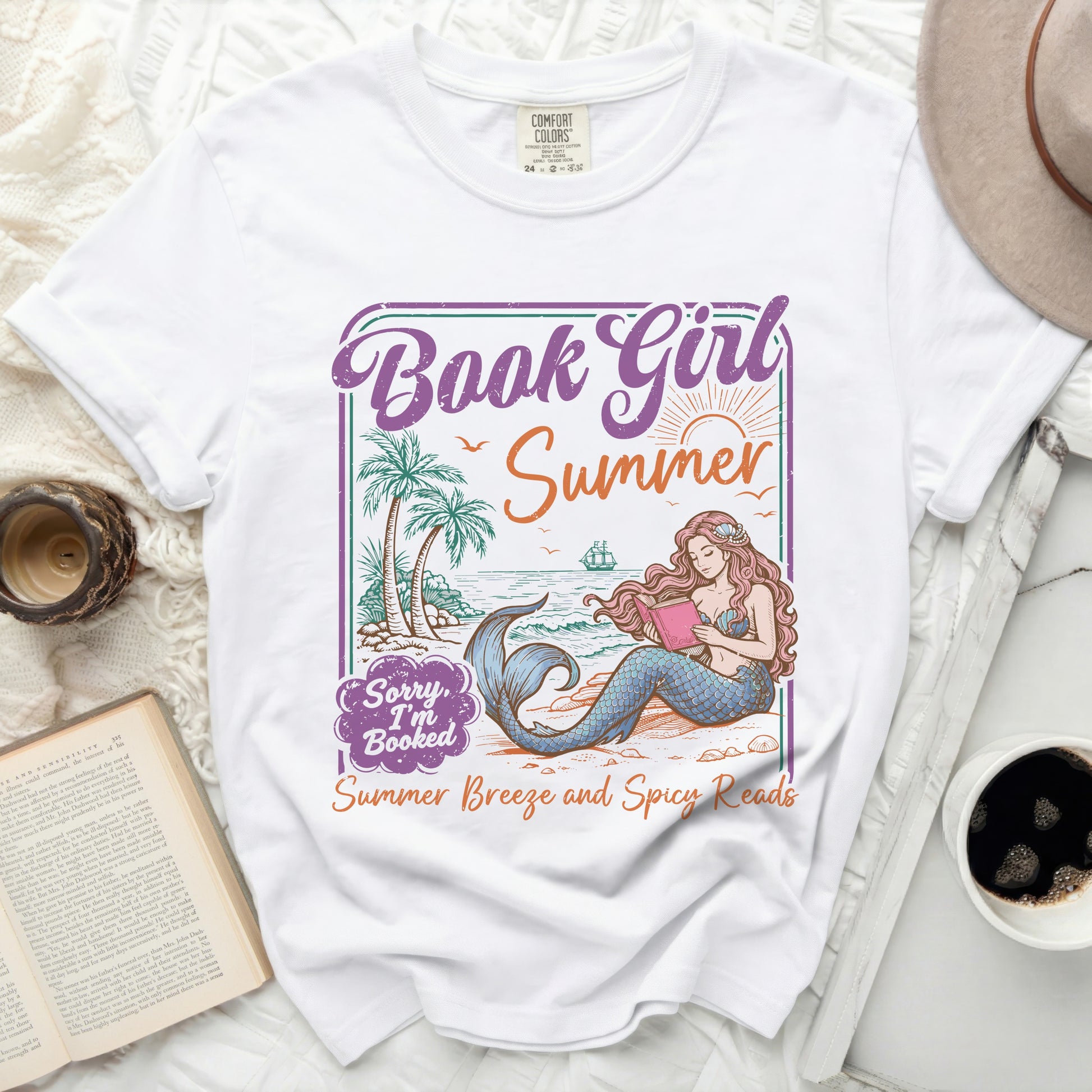 White t-shirt with a mermaid reading a book and "Book Girl Summer" text graphic.