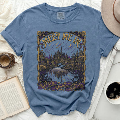 Blue t-shirt with "Meet me in The City of Starlight you know where" graphic.