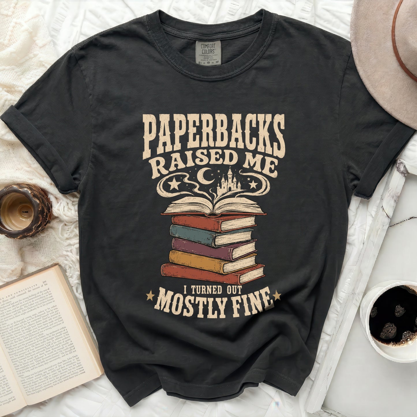 Dark t-shirt with "Paperbacks Raised Me" and books graphic.