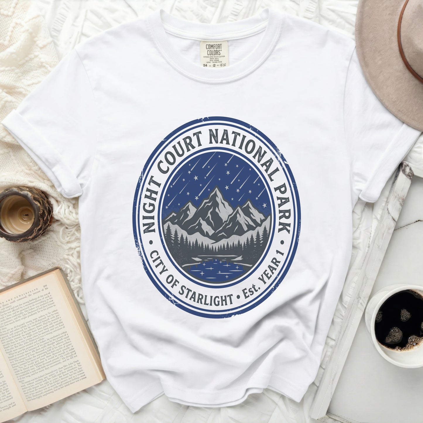White t-shirt with "Night Court National Park City of Starlight" circular graphic.