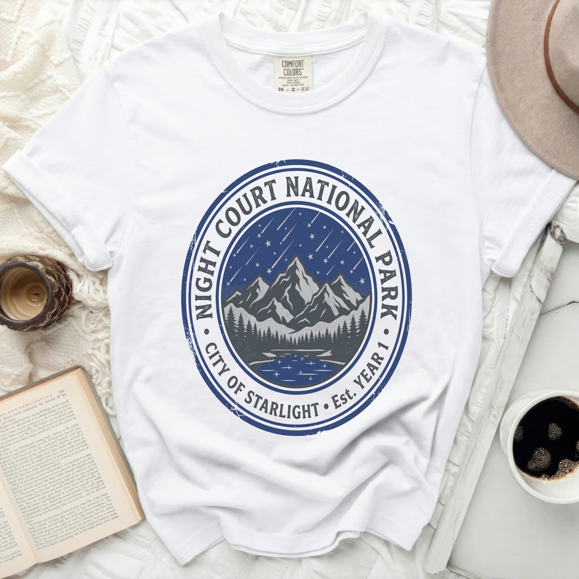 White t-shirt with "Night Court National Park City of Starlight" circular graphic.