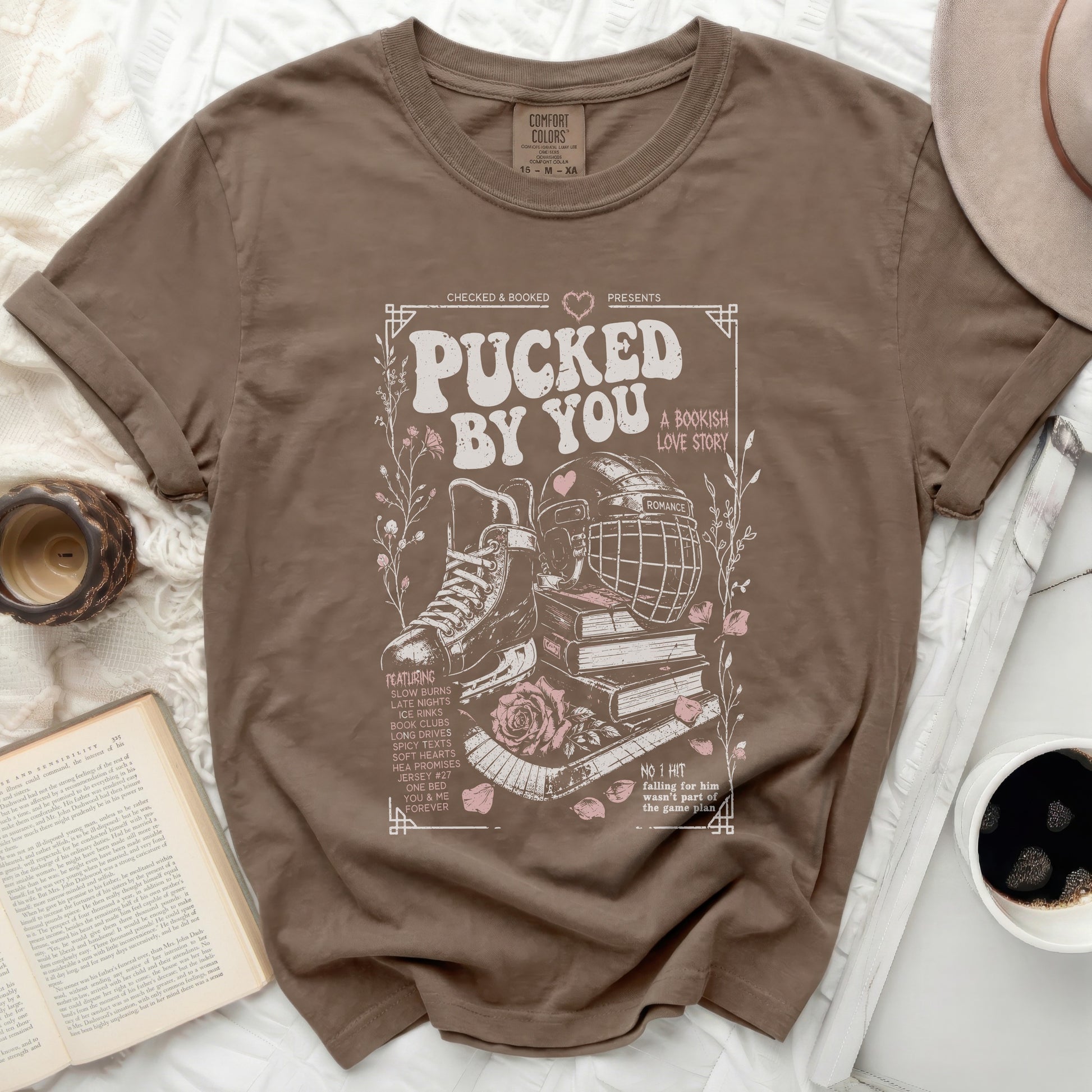 Brown t-shirt with "Pucked by You" romantic hockey bookish love story design.