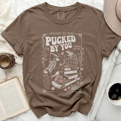 Brown t-shirt with "Pucked by You" romantic hockey bookish love story design.