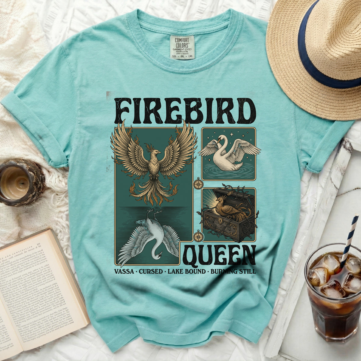 Teal t-shirt with "FIREBIRD QUEEN" graphic featuring a phoenix, swan, and treasure chest.
