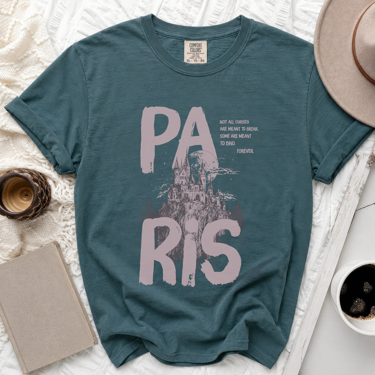 Teal t-shirt with "PARIS" text, castle graphic, and quote.