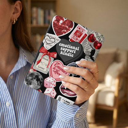 Kindle cover with "emotional support kindle" and various stickers including dice and cherries.