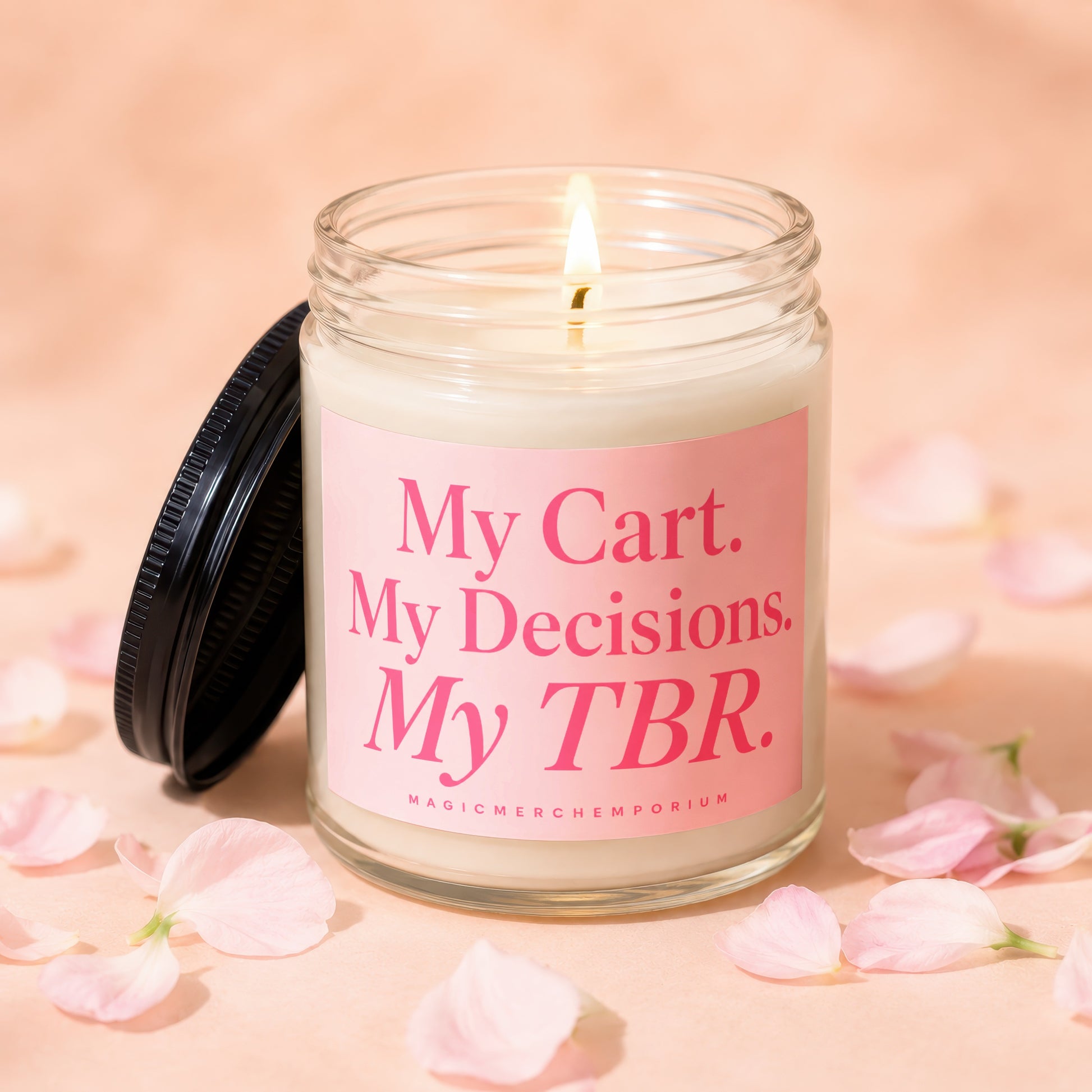 Lit glass jar candle with pink label reading "My Cart. My Decisions. My TBR."