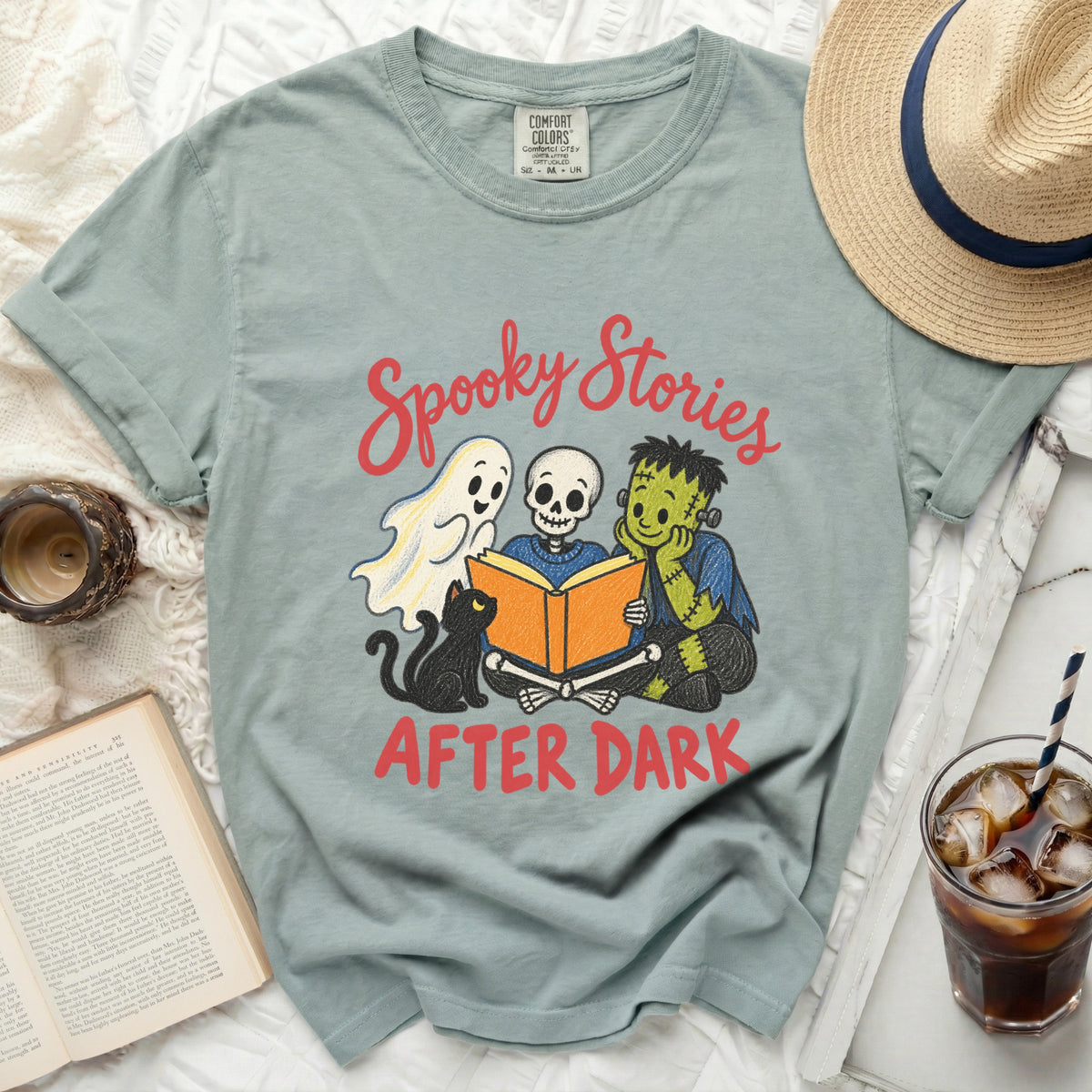 T-shirt with "Spooky Stories After Dark" text and Halloween characters reading a book.
