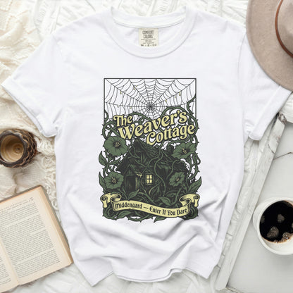 White t-shirt with "The Weaver's Cottage" design and "Middengard - Enter If You Dare" text.