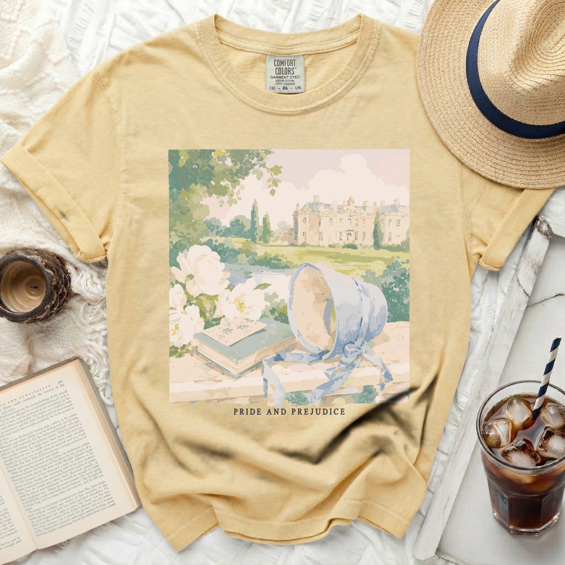 Yellow shirt with "Pride and Prejudice" artwork featuring a manor and books.