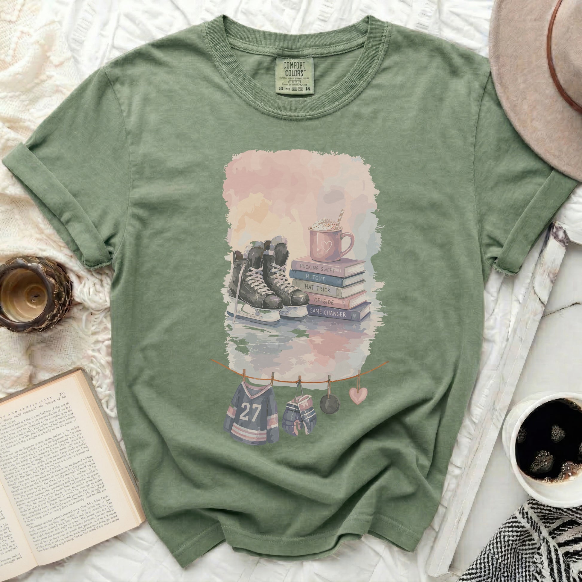 Green t-shirt with hockey skates, books, and text "PUCKING SWEET" and "GAME CHANGER".