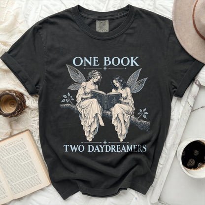Dark t-shirt with "ONE BOOK TWO DAYDREAMERS" and fairy artwork.