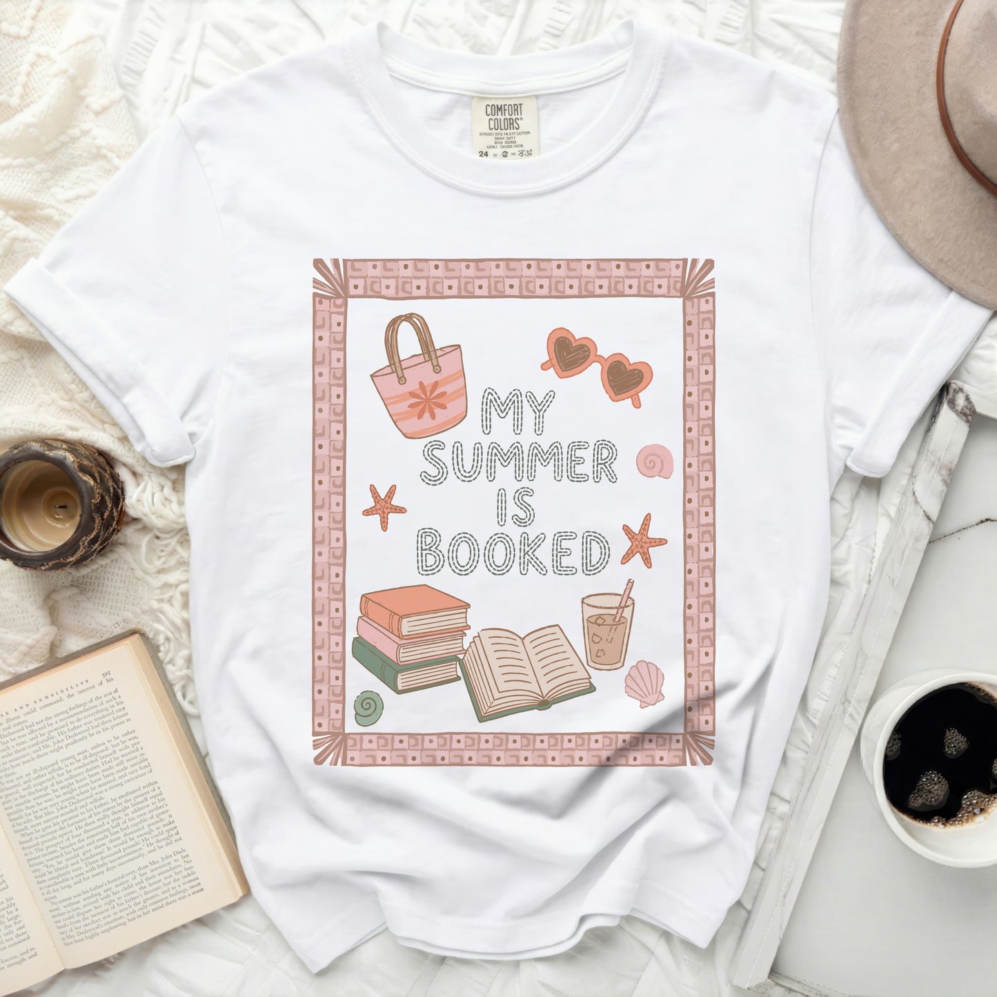 White t-shirt with "My Summer Is Booked" text and beach icons.