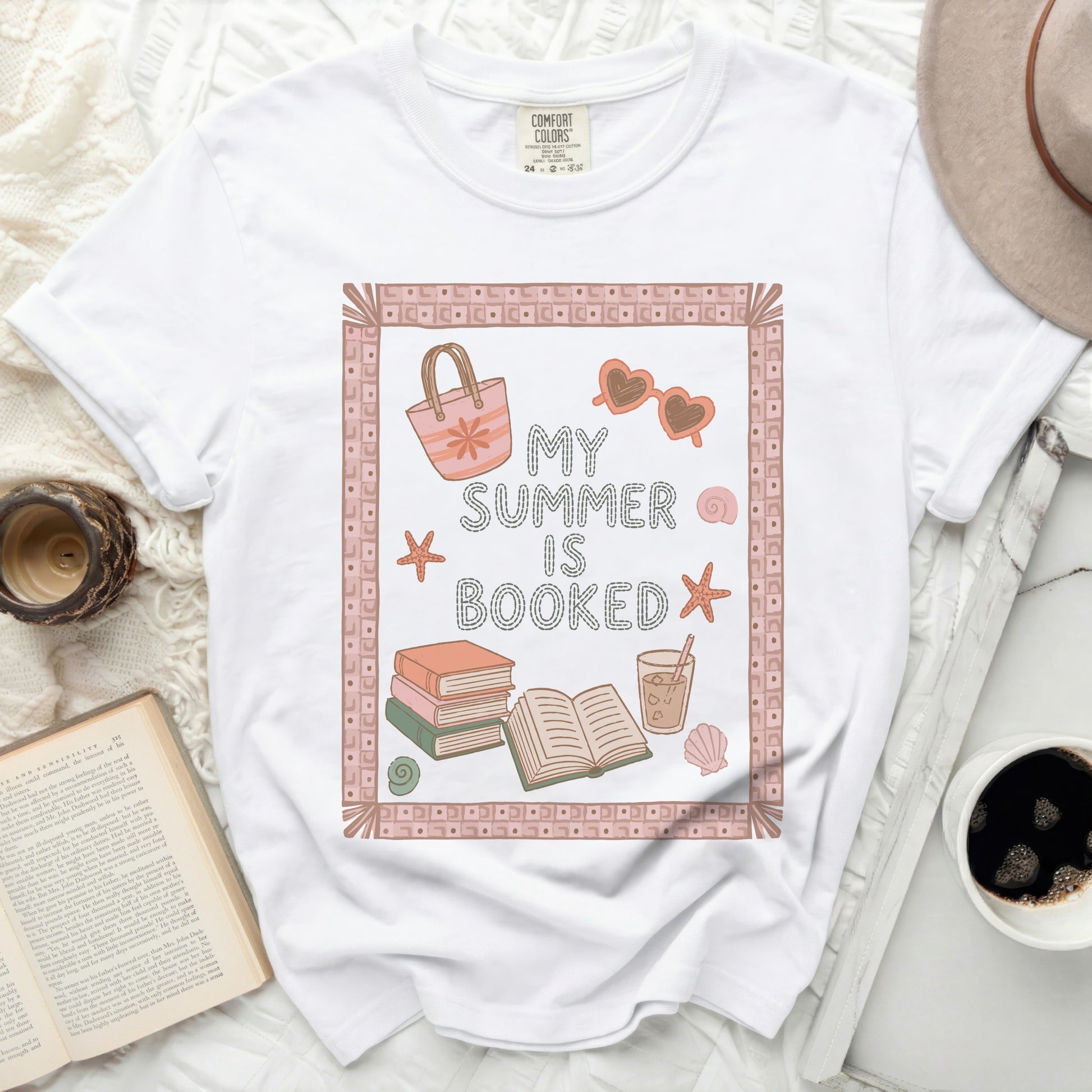White t-shirt with "My Summer Is Booked" text and beach icons.