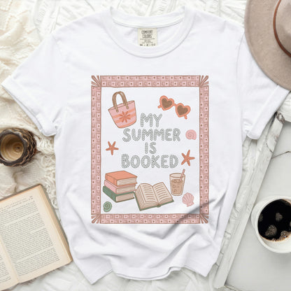 White t-shirt with "My Summer Is Booked" text and beach icons.