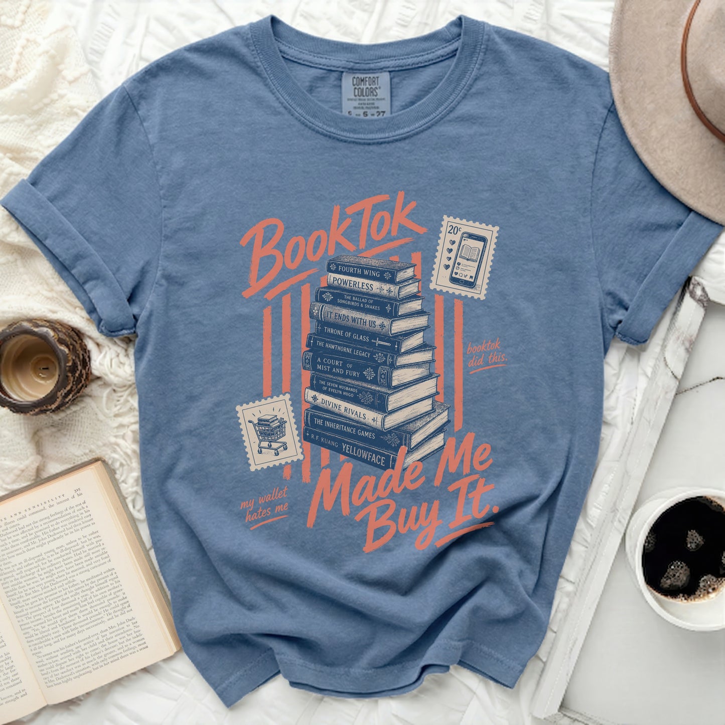 BookTok graphic on a blue t-shirt with stacked books and text "Made Me Buy It".