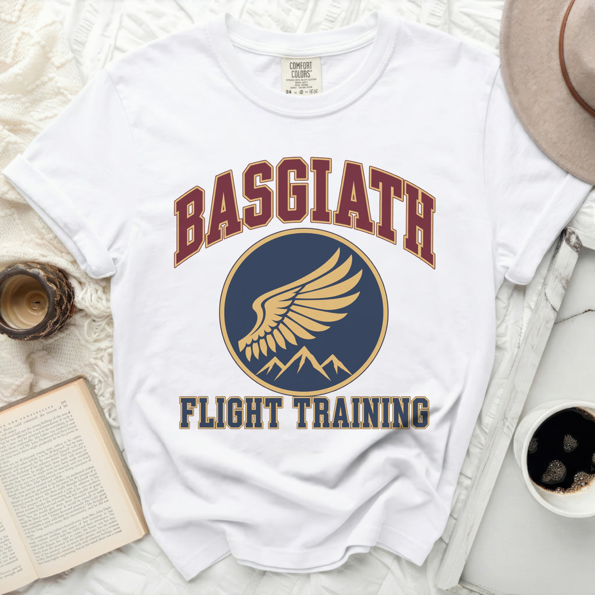 White t-shirt with navy and gold "BASGIATH FLIGHT TRAINING" graphic.