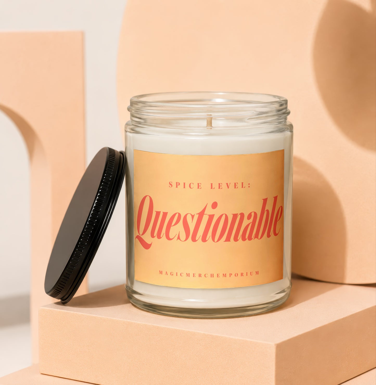 Candle with "Spice Level: Questionable" text and MagicMerch Emporium logo.
