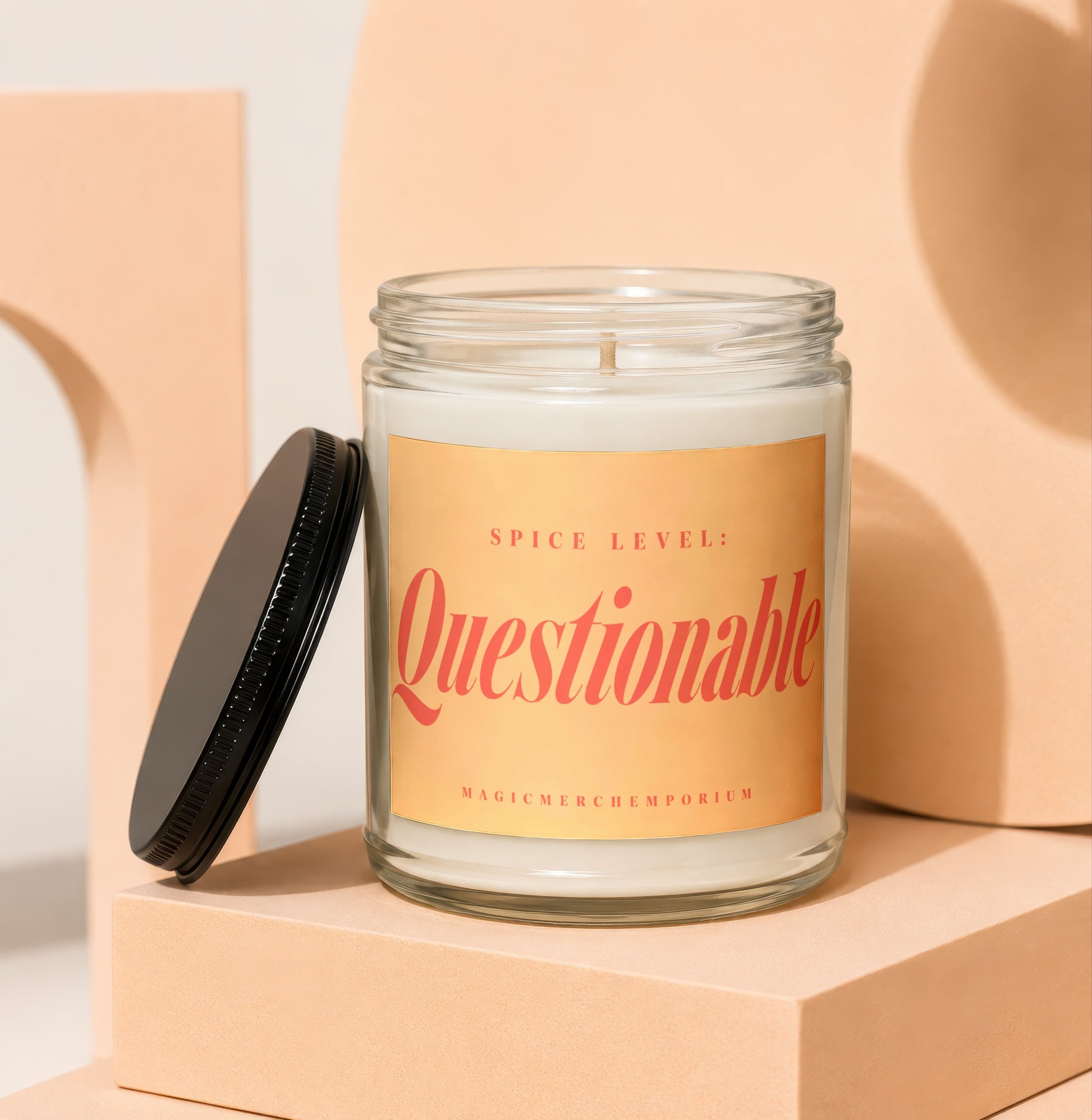 Candle with "Spice Level: Questionable" text and MagicMerch Emporium logo.