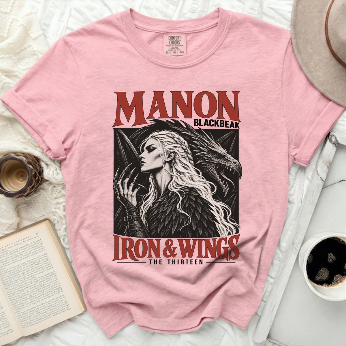 Pink t-shirt with "Manon Blackbeak Iron & Wings The Thirteen" graphic.