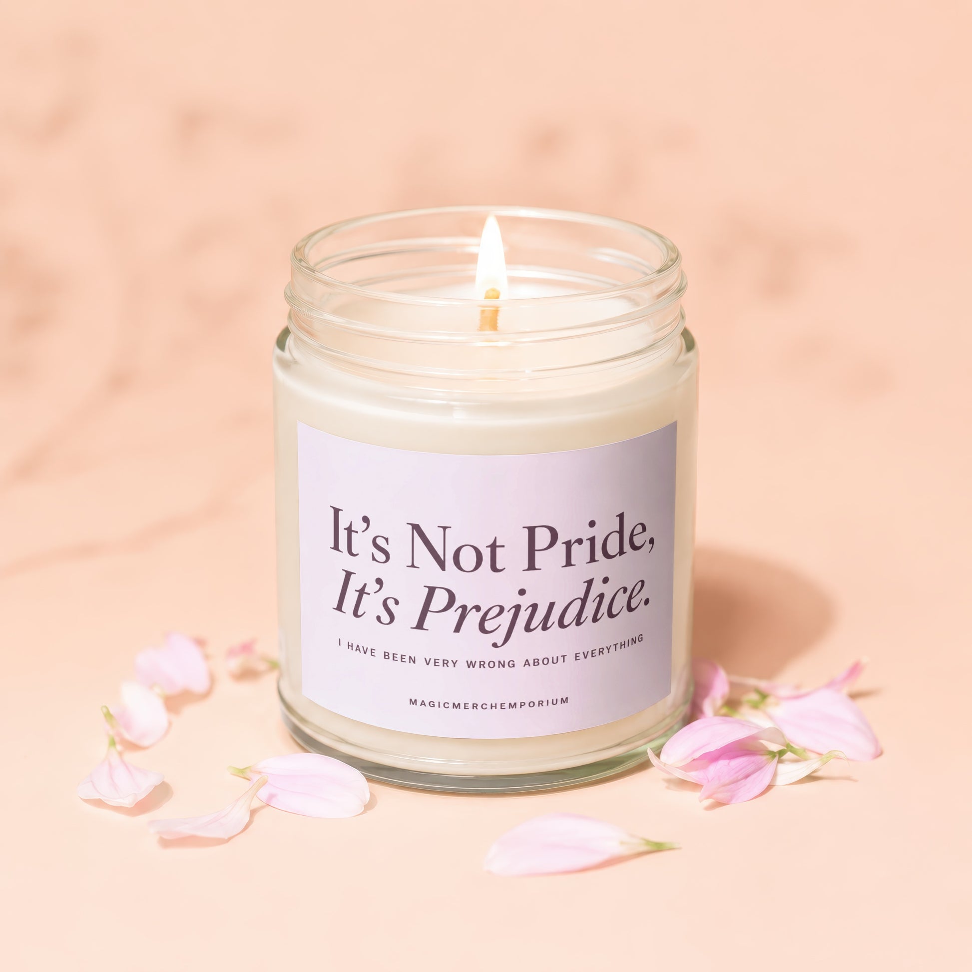 Candle with "It's Not Pride, It's Prejudice" quote and flower petals.