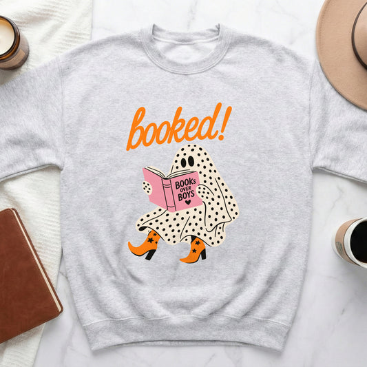 Light grey sweatshirt with a ghost reading a book that says "Books Over Boys".